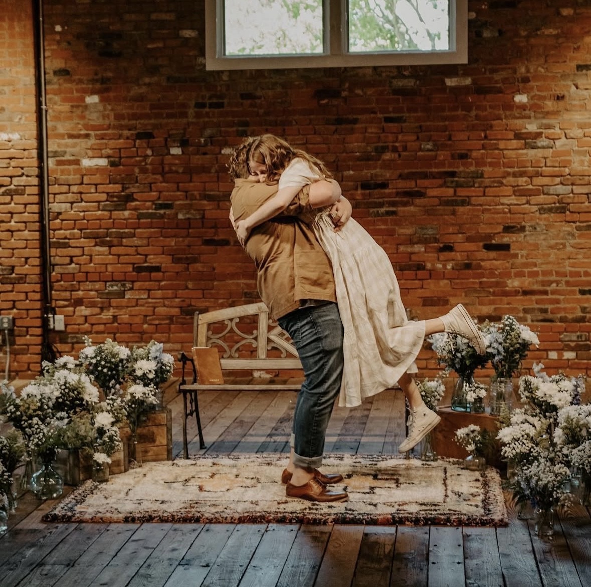 wedding proposals among exposed brick and wood floors of wedding venue ice house on main in bryan, tx